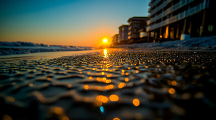 Fototapeta premium Sunrise over ocean beach, wet sand close-up.
