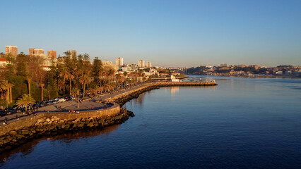 Fototapeta premium Vista capturando a deslumbrante paisagem do Porto e de Matosinhos, onde o Rio Douro encontra o Oceano Atlântico. A cena apresenta as areias douradas da praia de Matosinhos, 