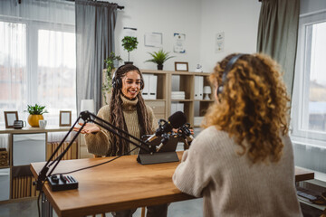 young woman presenter interview female guest and stream audio podcast