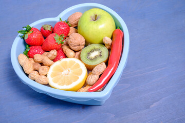 Heart shaped dish with vegetables isolated
