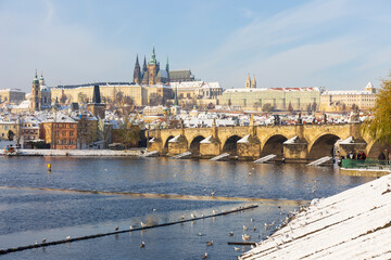 Snowy Prague Lesser Town with Prague Castle above River Vltava, Czech republic 