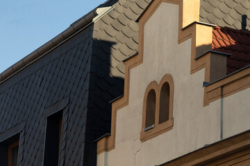 The roofline showcases a captivating blend of varied textures, unique shapes, and intriguing architectural elements