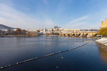 Fototapeta premium Snowy Prague Lesser Town with Prague Castle above River Vltava, Czech republic 