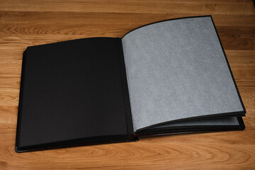 Traditional photo album lying on a wooden table
