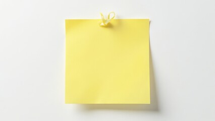 Blank yellow sticky note with bow on white background