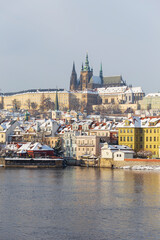 Fototapeta premium Snowy Prague Lesser Town with Prague Castle above River Vltava, Czech republic 