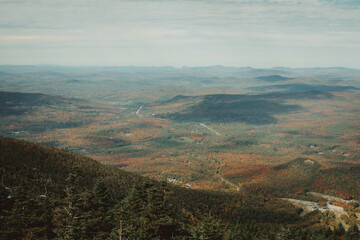 Foggy Autumn view of fall foliage in the morning from the top of the hill, New England