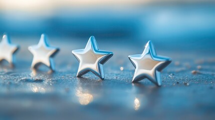 Four silver stars on a blue surface, symbolizing quality, rating, or achievement.