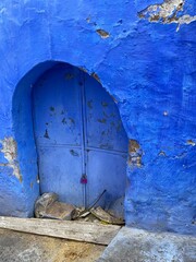 old door in a wall building chefchaouen hotel Morocco