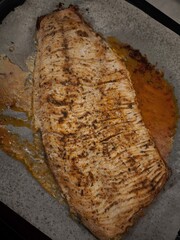 Delicious roasted carp fillet baking on parchment paper for christmas dinner