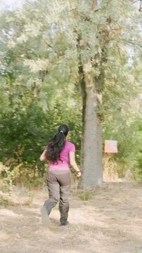 Venezuelan athlete navigating with map and compass in orienteering race. Young latinx venezuelan