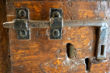 Ancient wooden door lock in a castle in Italy