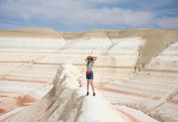 It is Kizilkup tract. There is a woman stands on the foreground. This hills look like tiramisu. © Родион Попов