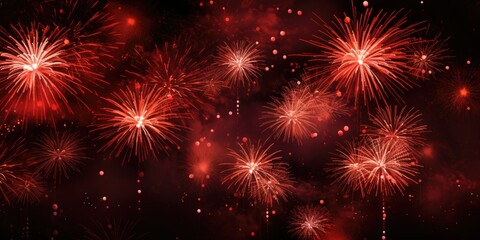 Fototapeta premium The image displays a lively fireworks show with red and white bursts against a dark background, creating a festive atmosphere.