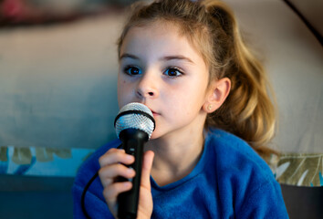 girl reading lyrics on screen while singing at karaoke