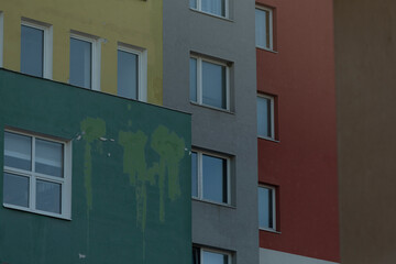 A vibrant multicolored building facade featuring an array of textures and intricate paint details that catch the eye