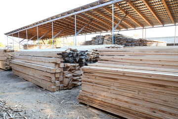 View of stacked wooden planks at sawmill