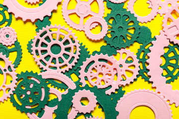 Different paper gears on yellow background