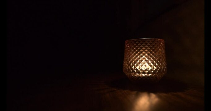Candle flame flickering in the glasswork