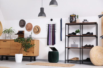 Interior of boutique with men's accessories, commode and shelf unit