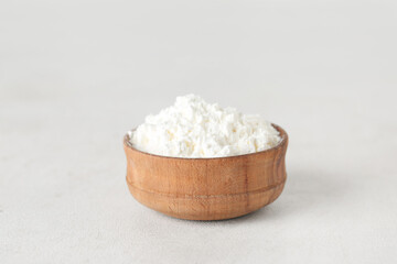 Bowl of powder pigment on light background