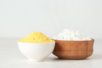 Bowls of powder pigments on light table, closeup