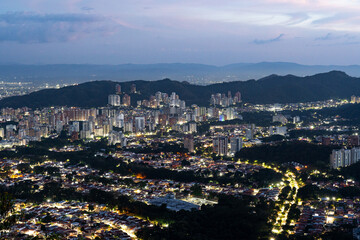 Fototapeta premium Night view of Valencia, Venezuela, as seen from Casupo mountain at dusk, creating a magical urban nightscape. Cityscape concept.