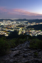 Night view of Valencia, Venezuela, as seen from Casupo mountain during blue hour at dusk, creating a majestic urban nightscape. Cityscape concept.
