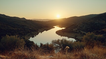 Fototapeta premium Serene sunset over a calm lake nestled in mountains.