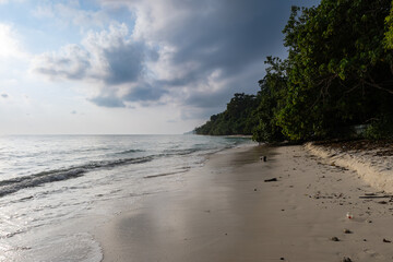 isolated sandy beach with dramatic sunrise sky at morning