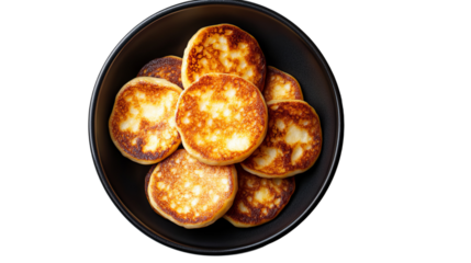 Cheese blini in a dark plate, top view, white background