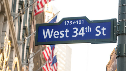 West 34th Street Sign in New York City with American Flags