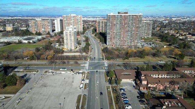 Low level aerial view of a corridor of high density high-rise buildings located near the Bramalea City Centre in Brampton Ontario. This clip is recorded on a mild February day.