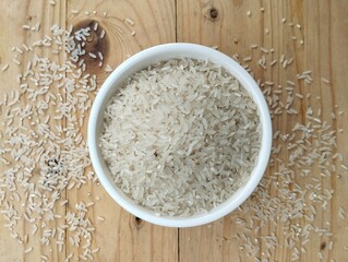 White rice in bowl on wooden table 