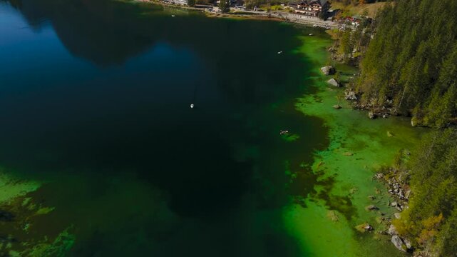 Hintersee in Ramsau, Germany captured from above in autumn, features turquoise waters of Ramsauer Ache, majestic Alps and Magic Forest. Enjoy boat rentals on this tranquil lake perfect for relaxation