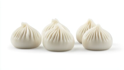 Obraz premium Four steamed buns, plump, white, and arranged on a white background.
