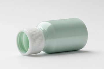A green plastic bottle with a white cap, lying on its side.