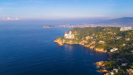 Aerial shot revealing the bay of Acapulco from Punta Bruja and the entrance to Puerto de Marques...