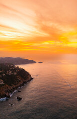 Beautiful sunrise at the entrance to Puerto Marques Bay in Acapulco. Warm colors paint the sky...