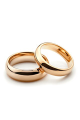  Close-up of two elegant gold wedding rings on a soft white background