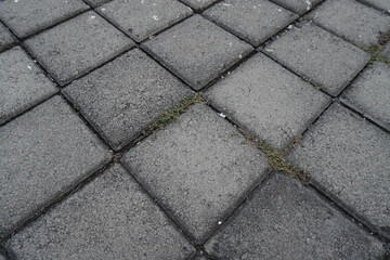 The background of the gray street paving is in the form of neatly arranged boxes