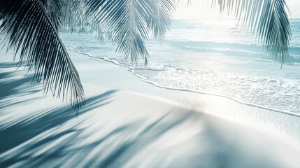 Serene beach scene viewed from under palm fronds.