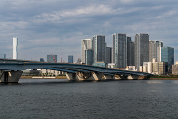 Fototapeta premium Harumiohashi Bridge and district of Chuo Harumi on reclaimed land, created by dropping earth and sediment generated from expanding Tokyo Bay, Tokyo, Japan