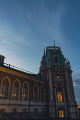 Gothic-style palace tower with arched windows at dusk