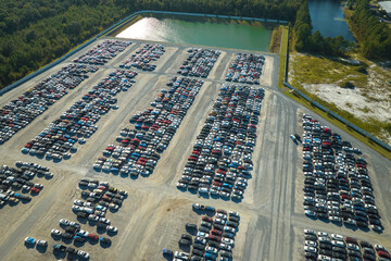 Aerial view of auction reseller company big parking lot with parked cars ready for remarketing...