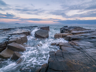 Moody Coastal Morning with Waves Crashing on Rocks