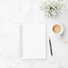Stylish flat lay of a blank notebook, coffee cup, elegant pen, and delicate flowers on a clean white surface, perfect for creative and business inspiration