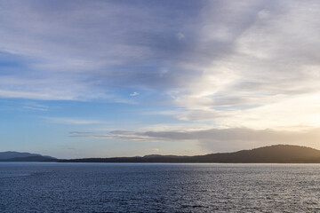 Tranquil Coastal Horizon Under a Peaceful Blue Sky at Sunset
