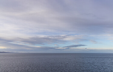 Serene Ocean View Under a Wide Spanning Cloudy Blue Sky