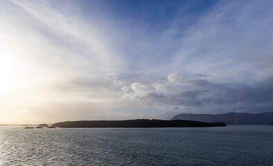 Serene Ocean View with Distant Island and Sunset on the Horizon